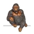 A BRONZE SCULPTURE OF A SITTING GORILLA