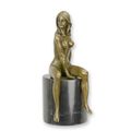 A BRONZE SCULPTURE OF A SITTING NUDE