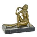 A BRONZE SCULPTURE OF A SITTING NUDE