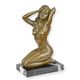 A BRONZE SCULPTURE OF A SITTING NUDE