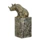 A BRONZE SCULPTURE OF A SITTING RHINOCEROS