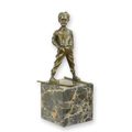 A BRONZE SCULPTURE OF A SKIER BOY