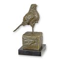 A BRONZE SCULPTURE OF A SMALL BIRD OF PREY
