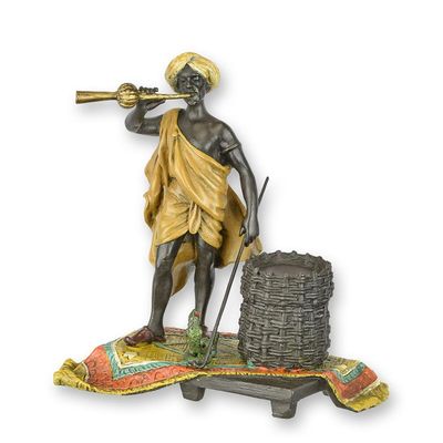 A BRONZE SCULPTURE OF A SNAKE CHARMER