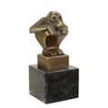 A BRONZE SCULPTURE OF A SQUATTING MONKEY
