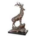 A BRONZE SCULPTURE OF A STAG ON ROCK