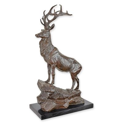 A BRONZE SCULPTURE OF A STAG ON ROCK