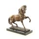 A BRONZE SCULPTURE OF A STALLION
