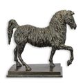 A BRONZE SCULPTURE OF A TROTTING HORSE