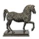 A BRONZE SCULPTURE OF A TROTTING HORSE