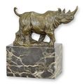A BRONZE SCULPTURE OF A WALKING RHINOCEROS