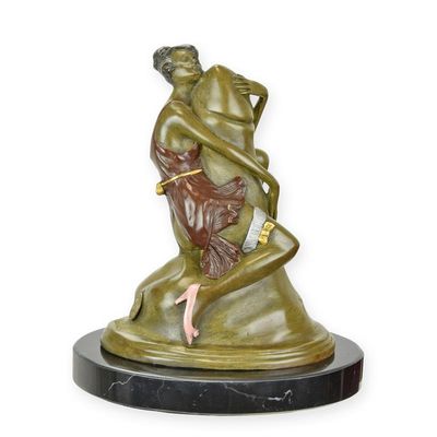 A BRONZE SCULPTURE OF A WOMAN EMBRACING A PHALLUS