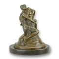 A BRONZE SCULPTURE OF A WOMAN EMBRACING A PHALLUS