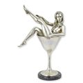 A BRONZE SCULPTURE OF A WOMAN IN A COCKTAIL GLASS