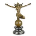 A BRONZE SCULPTURE OF A WOMAN ON TOP OF THE WORLD