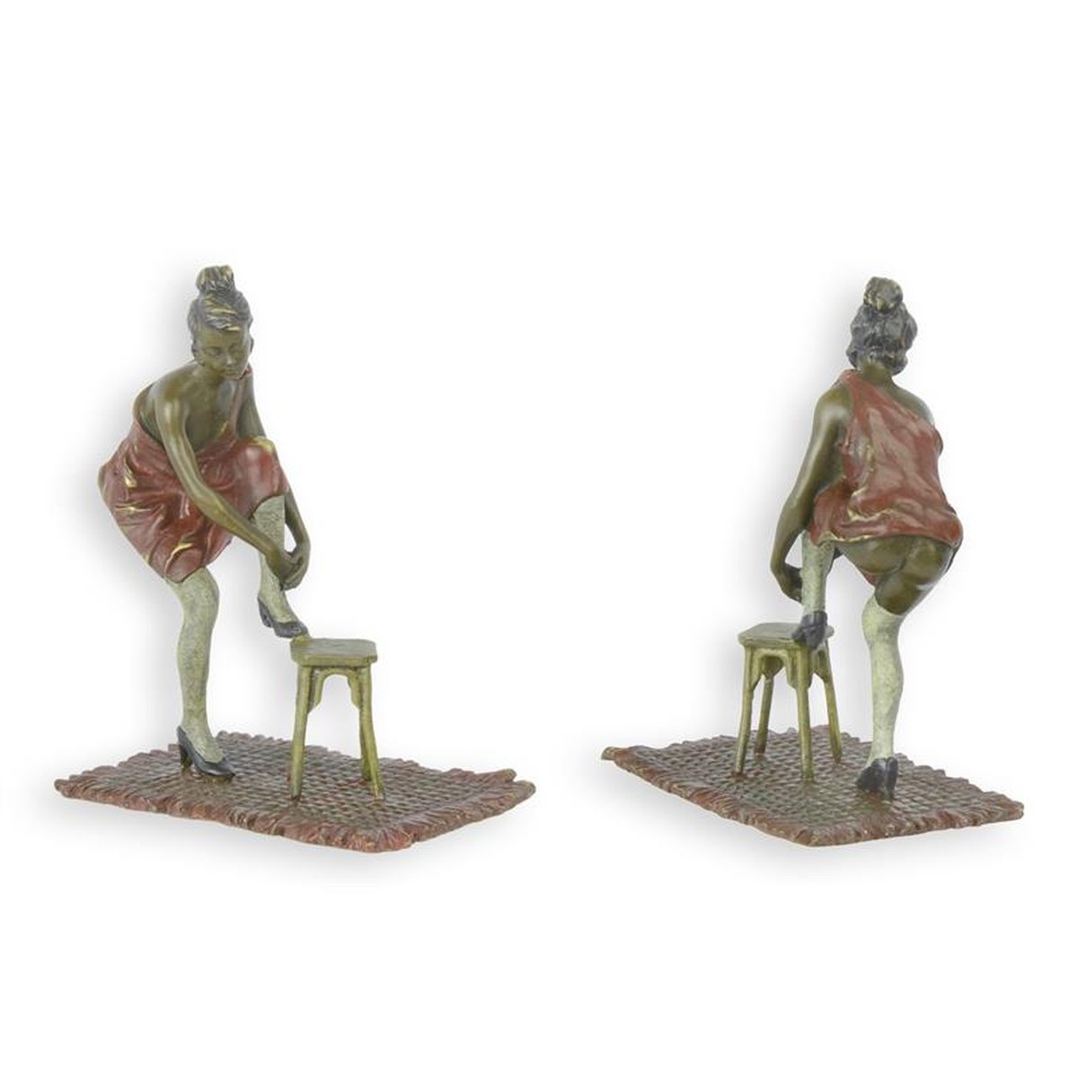 A BRONZE SCULPTURE OF A WOMAN PULLING UP HER PANTIES