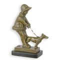 A BRONZE SCULPTURE OF A YOUNG GIRL WALKING HER DOG
