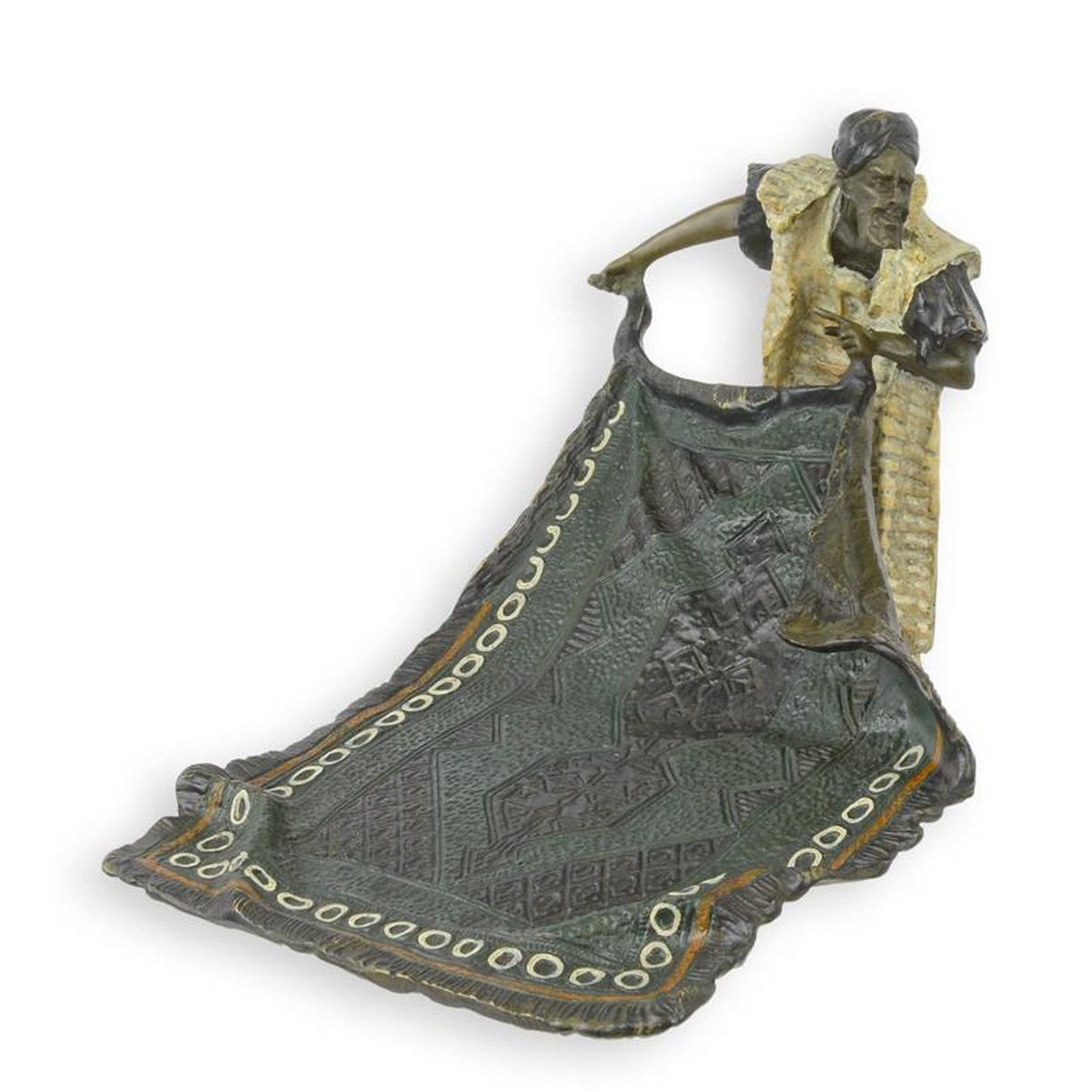 A BRONZE SCULPTURE OF AN ARAB CARPET SELLER