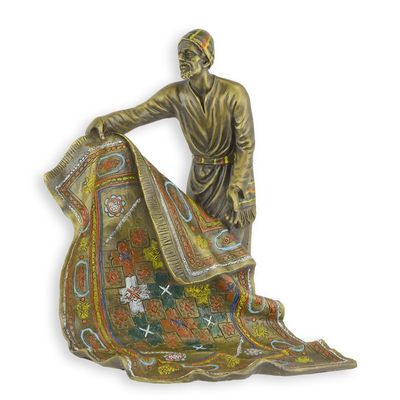 A BRONZE SCULPTURE OF AN ARAB CARPET SELLER