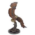 A BRONZE SCULPTURE OF AN EAGLE IN A FLIGHT