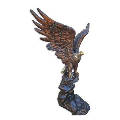 A BRONZE SCULPTURE OF AN EAGLE ON A ROCK