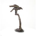 A BRONZE SCULPTURE OF AN EAGLE ON BRANCH