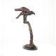 A BRONZE SCULPTURE OF AN EAGLE ON BRANCH