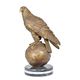 A BRONZE SCULPTURE OF AN EAGLE SITTING ON GLOBE