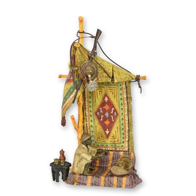 A BRONZE SCULPTURE OF AN ORIENTAL CARPET SELLER