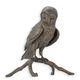 A BRONZE SCULPTURE OF AN OWL ON A BRANCH