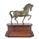 A BRONZE SCULPTURE OF TROTTING HORSE MOUNTED ON WOODEN BASE