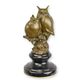 A BRONZE SCULPTURE OF TWO OWLS ON A BRANCH (BRASS PLATE UNDE
