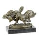 A BRONZE SCULPTURE OF TWO RUNNING HARES