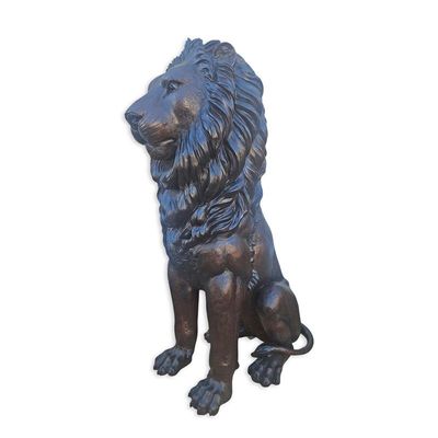 A BROZNE SCULPTURE OF A SITTING LION
