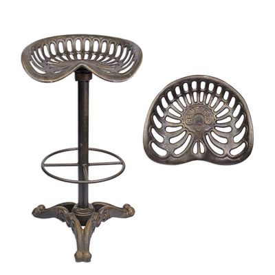 A CAST IRON BAR STOOL - BRONZE COLOUR