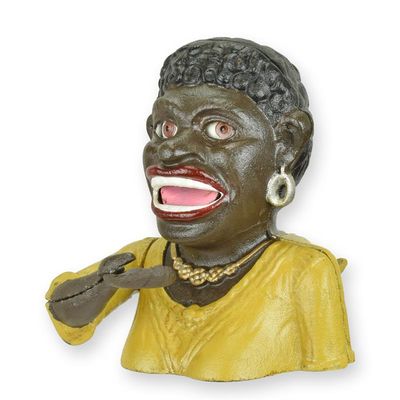 A CAST IRON BLACK LADY MECHANICAL BANK