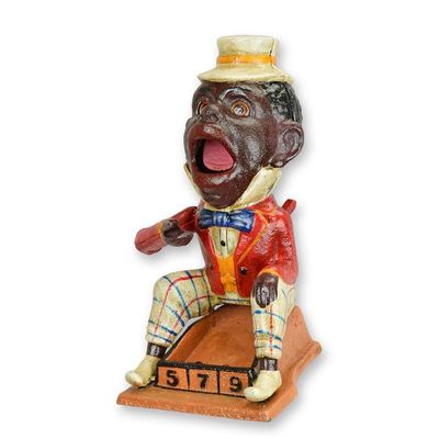 A CAST IRON BLACK MAN MECHANICAL BANK
