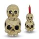 A CAST IRON DOUBLE SKULL CANDLE HOLDER