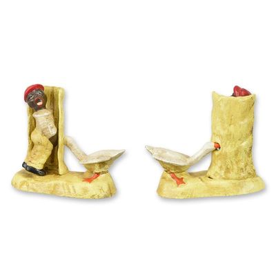 A CAST IRON FIGURINE OF A BOY PEEING AGAINST A FENCE