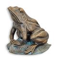 A CAST IRON FIGURINE OF A FROG SITTING ON A LOTUS LEAF