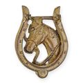 A CAST IRON HORSESHOE DOOR KNOCKER