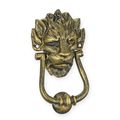 A CAST IRON LION HEAD DOOR KNOCKER