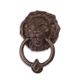 A CAST IRON LION HEAD DOOR KNOCKER