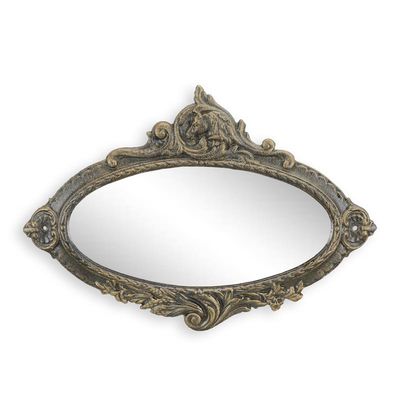 A CAST IRON OVAL MIRROR