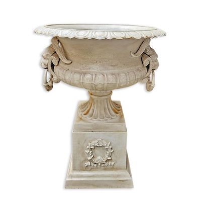 A CAST IRON PLANTER ON BASE