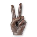 A CAST IRON SCULPTURE OF A PIECE SIGN HAND - RUST LOOK