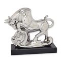 A CERAMIC FIGURINE OF A BULL