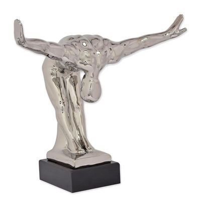 A CERAMIC FIGURINE OF A MALE NUDE BOWING