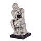 A CERAMIC FIGURINE OF THE THINKER