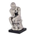 A CERAMIC FIGURINE OF THE THINKER